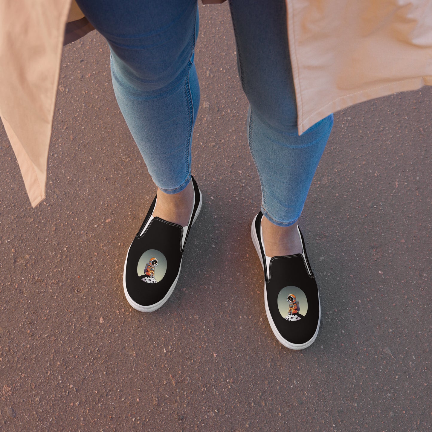 Image of a black pair of women's slip on canvas shoes featuring a cute astronaut Chihuahua dog sitting on a small moon.