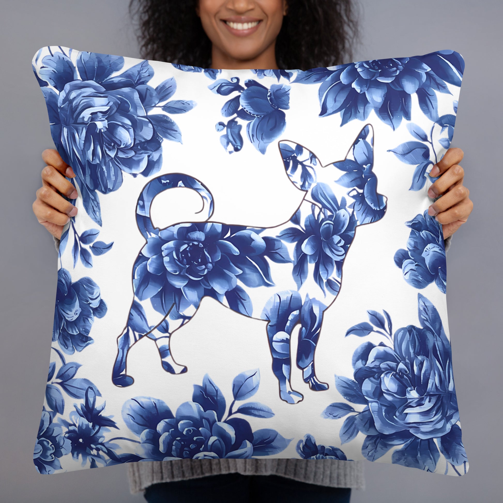 Photo of a woman holding a  22x22 inches throw Pillow printed with a floral motif of a Chihuahua silhouette with painted blue flowers.