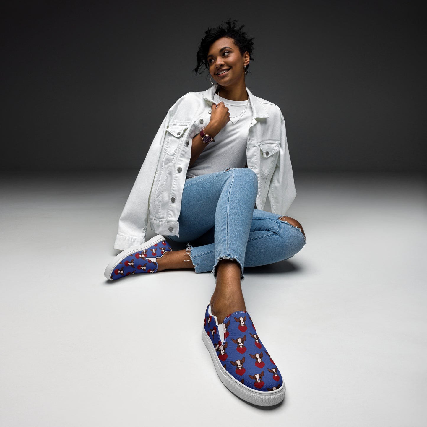 Photo image of a woman seating wearing pair of Blue women's canvas shoes with a Chihuahua themed pattern.