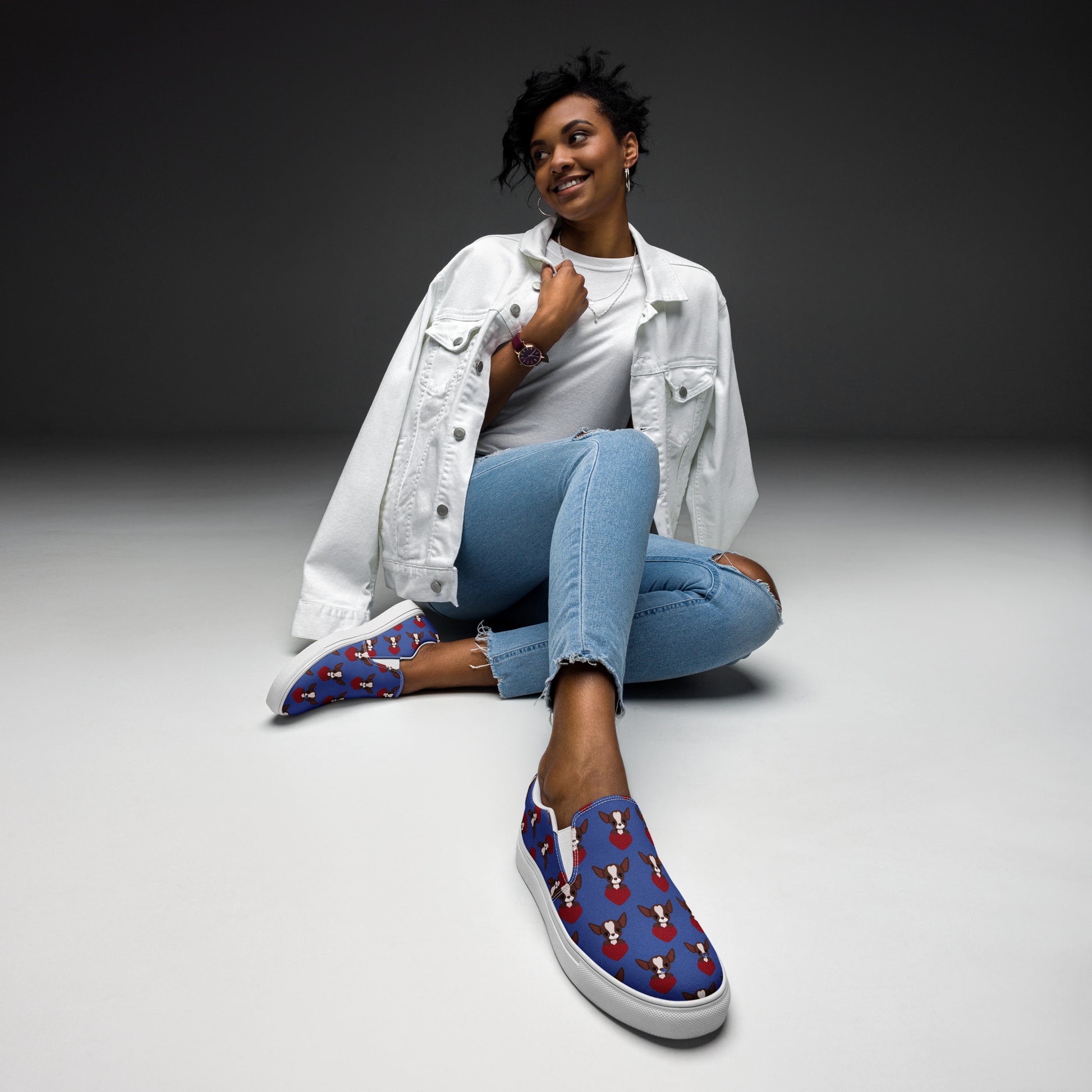 Photo image of a woman seating wearing pair of Blue women's canvas shoes with a Chihuahua themed pattern.