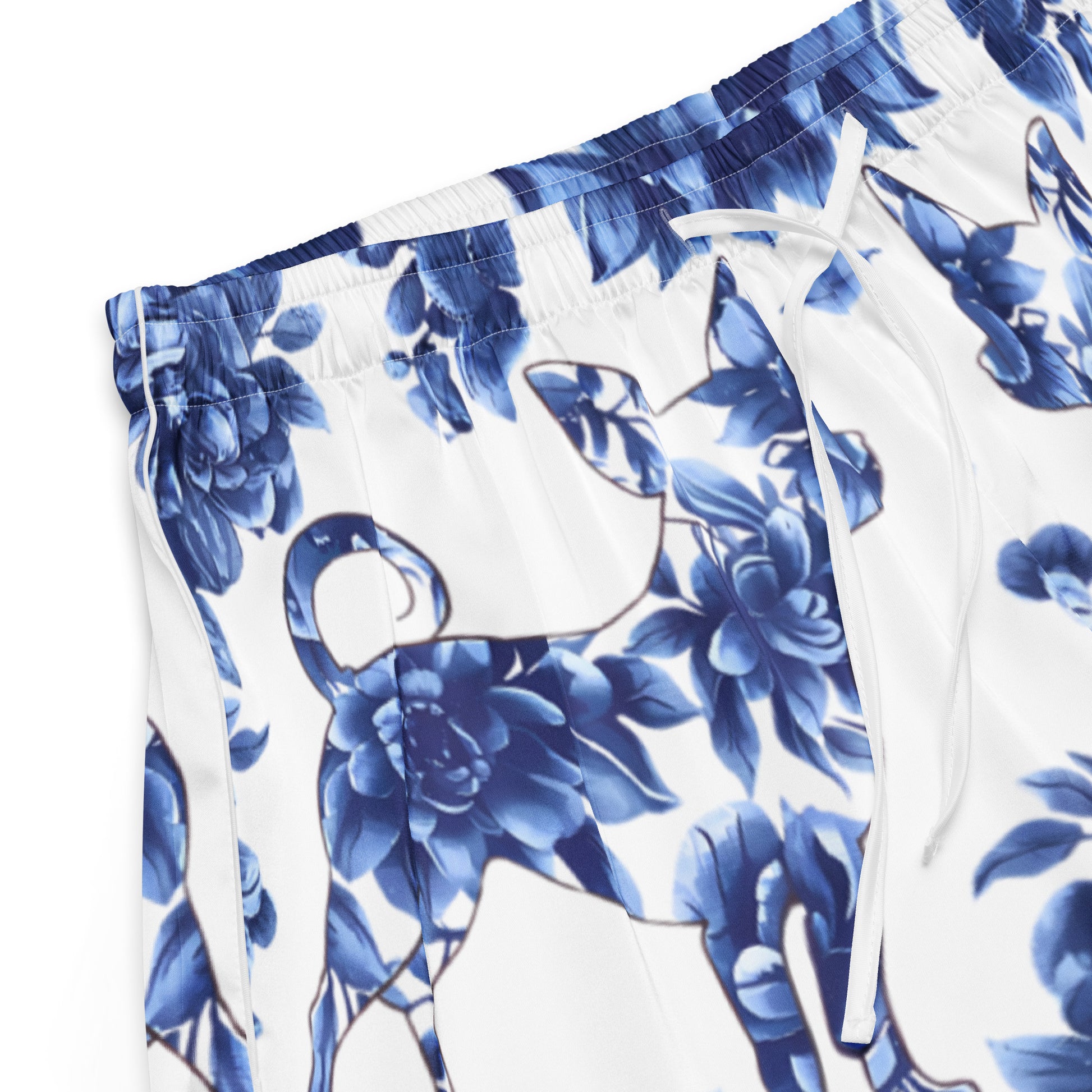 Close up photo of a pair of white color women's shorts printed with a blue floral motif. also featuring a Chihuahua silhouette adorned with blue flowers.